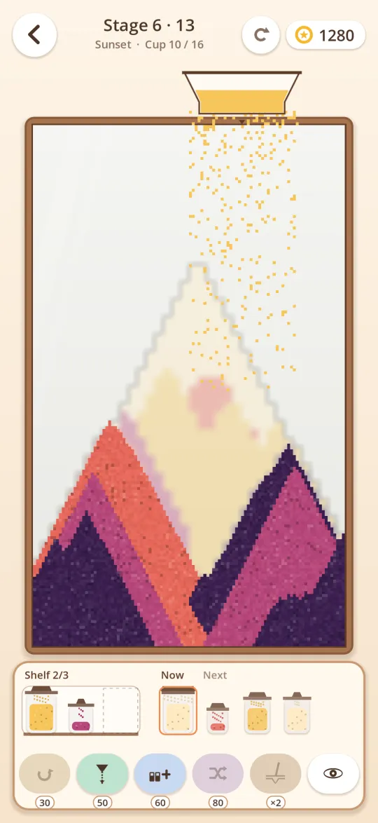 Pouring colored sand through the funnel